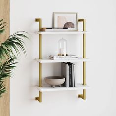 a white shelf with books and plants on it next to a plant in a vase