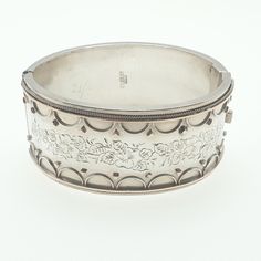 "A thick snap bangle bracelet made from sterling silver with hallmarks and date letter \"m\" for 1886. The bracelet weighs approx. 37.97 grams so is pretty heavy and chunky and the internal measurements from left to right are 6.19 cm. It is 31.93 mm wide and opens and closes as it should. PLEASE NOTE: There is a minor dent on the rear, captured best in the video. Stunning piece. Please check out the other items in my shop. Be sure to view all photos and videos for condition and read the titles a Luxury Antique Hallmarked Sterling Silver Bracelet, Luxury Traditional Antique Silver Bracelet, Victorian Hinged Cuff Bangle Bracelet, Victorian Hinged Bangle Bracelets, Victorian Hinged Cuff Bracelet, Antique Engraved Cuff Bangle Bracelet, Antique Engraved White Gold Bracelets, Victorian Engraved Cuff Bracelet For Anniversary, Victorian Etched Cuff Bracelet