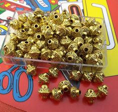 there are many gold beads in the box