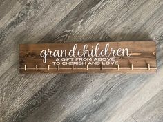 a wooden sign that says, grandchilden gift from above to cherish and love