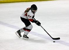 a female ice hockey player in action on the ice