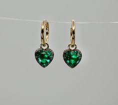 Lower prices on our main website: www.shopdiscomarshmallow.com A pair of beautiful hoop earrings with two approximately 0.50 carat heart shaped lab grown emeralds. In Georgian cut-down settings, the 0.5 ct Heart Shaped Emerald Hoop earrings are handcrafted in blackened 14K white and 14K yellow gold, on small 14K yellow gold hoops. With a total emerald weight is approximately 1 ct. Lab Grown Emeralds: Our lab grown emeralds are not synthetic, or treated. These are 100% emeralds just like a natura Heart-shaped May Birthstone Earrings For Anniversary, Heart Shaped May Birthstone Earrings For Anniversary, Elegant Green Heart Cut Earrings, Classic Pierced Heart Cut Jewelry, Elegant Green Earrings With Heart Charm, 18k Gold Earrings, Solid Gold Jewelry, Gold Hoops, Jewelry Earrings Hoops