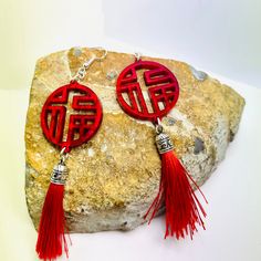 "Asian inspired red tassel earrings depicting a Chinese character \"good fortune\" pronounced Fú. Earrings are cut from 3mm red iridescent acrylic. These statement earrings are perfect for a special night out on the town. Earrings measured 3.75 inches long and 1.25 inches wide. They can be fitted with pierced or clip-on hardwares. Earrings will be placed in a gift box, carefully packed and shipped, perfect as a gift for yourself or a loved one. Any questions? Please feel free to contact me! See Earrings Asian, Red Statement Earrings, Laser Cut Earrings Acrylics, Iridescent Acrylic, Crescent Moon Earrings, Food Earrings, Glitter Earrings, Laser Cut Acrylic, Earrings Red