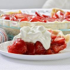 a close up of a plate of food with strawberries and whipped cream on it