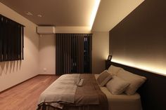 a large bed sitting in the middle of a bedroom next to a wall mounted air conditioner