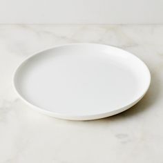 a white plate sitting on top of a marble counter