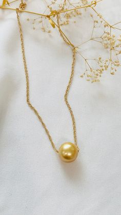 "Big and Beautiful Golden South Sea pearl adorns a 14k gold filled rope chain. - 12.5mm pearl  - 18-20\" rope chain -" Yellow Gold Round Pearl Necklace, Gold Akoya Pearl Necklace With Round Pendant, Pearl Necklace With Adjustable Chain, Round Pearl Necklace With Adjustable Chain, Yellow Gold Necklaces With Pearl Drop And Round Beads, Yellow Gold Necklace With Pearl Drop And Round Beads, Yellow Gold Pearl Necklace With Round Beads Pendant, Gold Akoya Pearl Round Pendant Necklace, Gold Pearl Necklace With Adjustable Chain