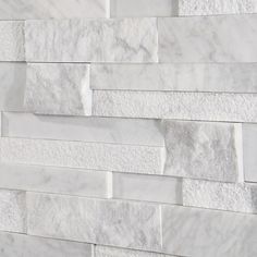 a white marble brick wall is shown