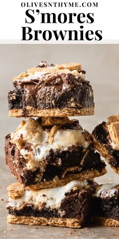 three brownies stacked on top of each other with white frosting and oreo cookies