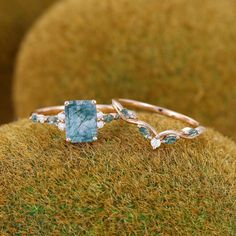 a close up of a ring on a mossy surface