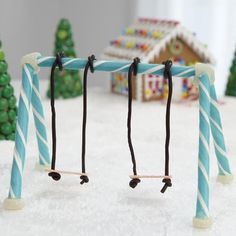 two blue and white candy canes sitting on top of a table next to christmas trees