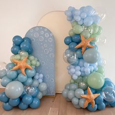 balloons and starfishs are arranged in the shape of letters