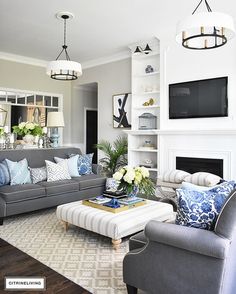 a living room filled with furniture and a flat screen tv mounted on the wall over a fireplace