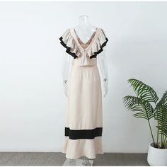 This is a sheath silhouette dress made of natural fiber. It has a halter collar, no decorations, and a pullover closure. The dress is designed for spring and summer and is suitable for middle-aged women. Fitted Beige Maxi Dress With Ruffles, Chic Beige Maxi Dress With Lace Trim, Beige Lace Patchwork Dresses For Summer, Beige Ruffled Maxi Dress For Vacation, Beige Ruffled Maxi Dress For Summer, Cream Halter Neck Maxi Dress For Summer, Beige Summer Maxi Dress With Ruffles, Sheath Silhouette Dress, Crop Suit