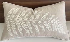 a pillow with white leaves on it