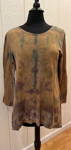 This One of a Kind comfortable tunic tee with asymmetrical hem - longer at both side seams- and 3/4 length sleeves, has a neckline that is comfortably between crew and scoop.  It has had several layers of natural dye (including indigo) as well as very subtle eco-printing (most visible in the second photo).  The garment was folded in different patterns with each dye bath.  The color is more varied in person than the photos suggest.  There is a very subtle geometric (octagon) pattern that was stamped along the hem with a solution used to shift color during the early stages of dyeing. Bohemian Hand Dyed Tops For Fall, Long Sleeve Tops In Natural Dye With Relaxed Fit, Casual Long Sleeve Tops With Natural Dye, Relaxed Fit Long Sleeve Top With Natural Dye, Bohemian Long Sleeve Washed Top, Spring Casual Tunic With Natural Dye, Pre-washed Long Sleeve Summer Tops, Oversized Hand Dyed Tops For Fall, Fall Hand Dyed Relaxed Fit Tops