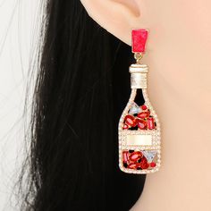 Red Champagne Bottle Rhinestone Earrings Length of the earrings is 6.5cm, width is 2cm. Sugar Boutique - ships from Shawnee, KS Family run boutique - ❤ Shipping and return info - https://www.sugarboutiquekc.com/pages/shipping-returns Red Crystal Metal Party Earrings, Red Metal Crystal Party Earrings, Red Crystal Metal Earrings For Parties, Valentine's Day Party Crystal Earrings, Crystal Earrings For Valentine's Party, Valentine's Day Party Crystal Metal Earrings, Valentine's Day Crystal Earrings For Party, Red Bling Earrings For Party, Red Rhinestone Evening Earrings