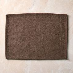 a close up of a brown towel on a marble surface