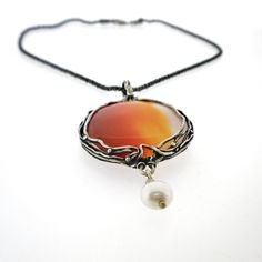 "From Porans collection ----> Unique Silver Pendant, amazing big natural Carnelian, 1 pearl hanging. Pendant Dimensions: Max Length: 78 mm\\ 3.12 inches Max Width: 38 mm\\ 1.52 inches The length of the chain is usually 18\" - 22\",  yet can be made at any size you wish, if you are interested in a specific length, Please! write a note on check out Please note - stone (carnelian) will be similar to the stone in the picture but can't be the same...  An amazing gift for yourself or loved ones!  Come Unique Round Pearl Pendant Jewelry, Elegant Orange Agate Jewelry, Elegant Carnelian Round Pendant Jewelry, Elegant Carnelian Pendant Necklace, Unique Pearl Pendant Jewelry, Carnelian Cabochon Round Pendant Jewelry, Bohemian Style Jewelry With Round Pearl Pendant, Silver Carnelian Cabochon Jewelry, Amber Cabochon Round Pendant Necklace