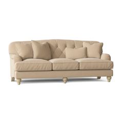 a beige couch with pillows on it