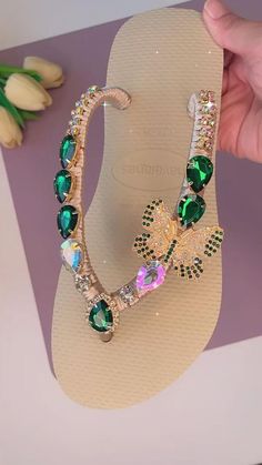 This is a collection of elegant and luxurious thong sandals that are adorned with dazzling rhinestone crystals. Designed for brides and weddings, these sandals combine comfort with a touch of glamour, making them ideal for walking in style on special occasions. Jewel-encrusted Havaianas with the sparkle of crystals make them a perfect accessory for high-end events and weddings, adding a touch of luxury to your bridal wardrobe or any occasion that requires sophisticated footwear. Wonderful sanda Glamorous Green Sandals With Rhinestones, Flat Rhinestone Flip Flops For Beach, Rhinestone Flat Flip Flops For Beach, Bling Open Toe Sandals For Beach, Rhinestone Beach Flip Flops, Summer Crystal Sandals With Rhinestones, Crystal Rhinestone Sandals For Summer, Elegant Crystal Sandals With Bling, Crystal Open Toe Sandals With Bling