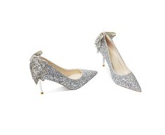 These silver heels are perfect for a night out or a special occasion. The bow brooch adds a touch of glamour and femininity to the overall look. The silver hue is timeless and easy to pair with any outfit. Whether you're looking for a dressy option for a special event or an everyday staple, these silver heels are sure to make a statement. Elegant High Heel Holiday Heels, Glamorous Bow Heels For Formal Occasions, Chic Wedding Shoes With Bow For Parties, Glamorous Formal Heels With Bow, Elegant High Heels For The Holidays, Elegant Holiday High Heels, Elegant Holiday Heels For Events, Elegant Evening Heels For Holidays, Formal Wedding Shoes With Bow