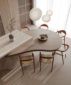 a wooden table with chairs around it in front of a wall mounted vase and lamp