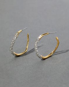 The Medium Two Tone Pave Hoop Earrings feature dual powers of champagne crystal pave and 14k gold plated metalwork in a classic hoop design. Modern Gold Earrings With Pave Setting, Gold Metal Hoop Earrings With Rhinestones, Modern Gold Hoop Earrings With Pave Setting, Gold Hoop Earrings With Pave Setting, Gold Hoop Earrings With Crystal, Gold Crystal Hoop Earrings With Rhinestones, Modern Gold Diamond Hoop Earrings, Modern Gold Earrings With Sparkling Stones, Gold Metal Hoop Earrings With Sparkling Stones