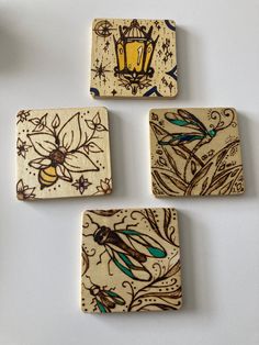 four square coasters with designs on them