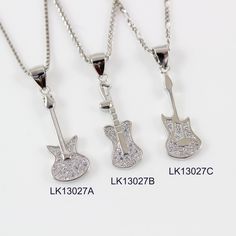 "LarkKing LK13027 Sterling silver Guitar necklace, silver music necklace, electric guitar necklace, silver bass guitar pendant, rock music jewelry, string instrument necklace. There are 3 styles of guitar pendants available. Pendant material: White gold plating sterling silver with cubic zirconia crystal, solid 925 sterling silver Necklace Chain: High quality unique solid 925 sterling silver chain with white gold plating, see the above image. To select style of guitar pendant from the drop down Sterling Silver Jewelry For Concerts, Silver Rock Jewelry For Concerts, Silver Rock Style Jewelry For Concerts, Silver Rock Style Jewelry, Silver Rock Style Necklace As Gift, Silver Rock Style Necklace Gift, Silver Rock Style Necklace For Gift, Opal Moon Necklace, Guitar Necklace