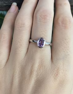 "A Dainty Stackable Oval Genuine Purple Amethyst set in a simple bezel handcrafted in sterling silver is a great birthstone ring for those February Birthdays! This also makes an ideal ring to stack with our other gemstone ring or wear it as a MIDI/PINKY Ring. Wrapped in a box ready for gift giving. BELESAS and 925 hallmarked inside the ring. (r-gem-4) Ring Info ----------------------------------------- Genuine Purple Amethyst measure 6mm x 8mm High Quality 925 Sterling Silver Tarnish Resistant S Promise Solitaire Stackable Rings, Oval Amethyst Promise Ring With Accent Stones, Oval Amethyst Promise Ring With Prong Setting, Oval Solitaire Stackable Promise Rings, Oval Gemstone Stackable Rings For Promise, Oval Gemstone Stackable Promise Rings, Promise Jewelry With Oval Amethyst, Oval Amethyst Promise Ring In Purple, Oval Purple Amethyst Promise Ring