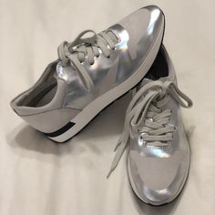 Brand New, Without Box, Free People Aida Kick It Lace Up Sneakers In Silver Metallic. They Were Originally $128 And I Bought Them On Sale For $99.95. I Was Super Excited To Wear Them But, Unfortunately, My Shoe Size Changed When I Was Pregnant And I Never Got To Wear Them. The Size Is A European 38 Which Translates To A Us7 Or 7.5 Depending On Brand. These Are Marked A 7 But Fit More Like A 7.5 In My Opinion. They Are Suede And Leather With The Coolest Iridescent Silver Metallic And Gray Color. Modern Metallic Silver Sneakers With Round Toe, Casual Metallic Silver Sneakers With Reflective Details, Silver Casual Sneakers With Reflective Details, Modern Silver Sneakers With Laces, Modern Metallic Silver Round Toe Sneakers, Silver Lace-up Sneakers For Running Errands, Casual Silver Sneakers With Reflective Details, Metallic Silver Leather Sneakers With Round Toe, Silver Metallic Leather Sneakers With Round Toe