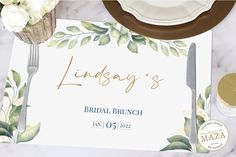 the bridal brunch menu is laid out on a marble table with silverware and flowers