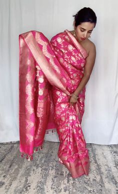 This stunning pink 100% Mulberry Katan silk saree is handwoven in Banaras, known for its intricate designs and high-quality craftsmanship. The saree features a beautiful shade of dual pink with gold and silver  zari jaal work creating a mesmerizing effect. Loolong for a distinct saree - this is the one with silver zari outlining . The saree is perfect for any special occasion, such as a wedding, festival, or formal event. Comes finished with hand fall and Pico. And a blouse piece with zari border. Silk Mark Certified Note: Colors that show up on your screen may vary slightly from the actual product due to variations in settings. Also, the actual product may appear to be different hues depending on the ambience lighting. Note: There may be very slight inconsistencies such as in the weave/mo Festival Banarasi Silk Pre-draped Saree With Tilla, Transitional Pink Raw Silk Pre-draped Saree, Transitional Pink Saree With Zari Work, Pink Art Silk Pre-draped Saree For Transitional Season, Pink Paithani Silk Pre-draped Saree For Traditional Ceremonies, Transitional Pink Banarasi Silk Pre-draped Saree, Transitional Season Pink Banarasi Silk Pre-draped Saree, Traditional Pink Raw Silk Pre-draped Saree, Pink Raw Silk Pre-draped Saree For Transitional Season