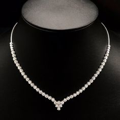 She'll never tire of wearing this classic and sophisticated diamond tennis necklace. Stunning in 18K solid white gold, this breathtaking line of shimmering round diamonds. So elegant, this 18.0-inch diamond necklace will take her breath away. Radiant with 3.08 cts. t.w. of diamonds and buffed to a brilliant luster, this glamorous keepsake secures with a box clasp. The setting design make the diamonds look much bigger than they are. When worn, the diamonds look like 1/5 carat each. Diamonds Detai Wedding Tennis Necklace With Brilliant Round Cut, Brilliant Cut Tennis Necklace For Wedding, Classic Diamond Tennis Necklace For Wedding, Silver Tennis Necklace With Single Cut Diamonds For Wedding, Timeless Diamond White Tennis Necklace For Wedding, Wedding Tennis Necklace In White Gold With Round Cut, White Gold Tennis Necklace With Vvs Clarity For Wedding, Wedding Silver Tennis Necklace With Prong Setting, Vvs Clarity White Gold Tennis Necklace For Wedding