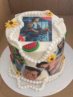 a cake decorated with pictures and flowers on a plate