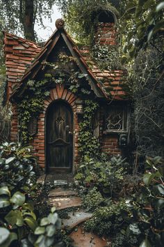 an old brick house with ivy growing on it's roof and door, surrounded by greenery