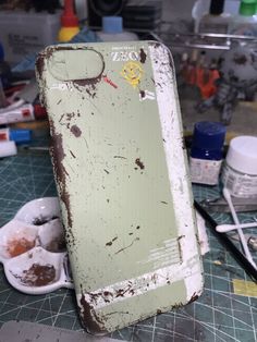 an old green refrigerator sitting on top of a counter next to bowls and spoons