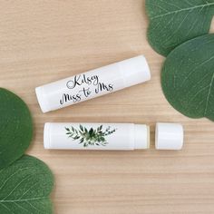 Our Personalized Lip Balms have a beautiful green leafy design that will match nicely with any wedding or bridal shower.  Each stick of lip balm features a white exterior and contains balm made with Shea Butter, Beeswax, Vitamin E, and Aloe Vera.  Your choice to easy assembly with self-adhesive labels or we can assemble them for you Proudly made in the USA. Personalization - maximum characters per line including spaces; Line 1: 20, Line 2: 20 Personalized Lip Balm, Lip Balm Favors, Bridal Shower Favor, Favors Wedding, Bridal Shower Favors, Green Leaf, Wedding Favours, Vitamin E, Lip Balm