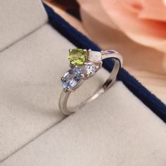 Peridot Opal Cluster Engagement Ring Personalized Multi-stone Aquamarine Moissanite Wedding Ring Birthstone Family Ring Art Deco Anniversary Specification: Stone Name - Peridot, Aquamarine, Opal, Moissanite Shape - Cushion, Oval, Princess Cut, Round Color - Green, Blue, White, White Size - 5mm, 6x4mm , 3mm, 2mm Cut - Faceted Metal Type - 92.5 Sterling Finished With Rhodium Ring Size: We make rings from US 4 to US 16. (If you need smaller or bigger ring size, please ask me to resize) Country of Manufacture: India -------------------------------------------------------- Payment Accepted By PayPal Free Shipping  Standard Delivery Under free shipping services parcel will be delivered within 15 days from the date of dispatch. Speed Delivery : For Fast Delivery kindly pay 30.00 USD extra. Please Rhodium Ring, Family Ring, Silver Opal Ring, Family Rings, Multi Gemstone Ring, Aquamarine Engagement Ring, Ring Birthstone, Cluster Engagement Ring, Aquamarine Ring