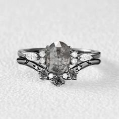 a close up of a ring with a stone and diamonds on the bottom, in black and white