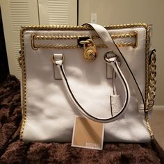 Used Once 100% Authentic Interior: Zipper Pocket, And 4 Multifunction Slip Pockets, Key Clip Exterior: Micro Studs All Around The Edges & Belt Also A Front Michael Kors Lock(That Has A Small Scratch On Back-Image #5) & A Michael Kors Hanging Key Logo Double Handle With Shoulder Strap Color: White Bottom Feet Exterior Gold One Hardware Detail Tote Embosed Leather Drop: 6.5" Top: 13", Bottom: 14"(W) 12"(H) Key Logo, Michael Kors Tote Bags, Key Clip, Michael Kors Hamilton, Womens Tote Bags, Zipper Pocket, Tote Bags, Top Handle Bag, Shoulder Strap