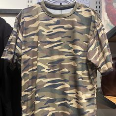 Step up your style game with our Unisex Tiger Stripe Camo T-Shirt. This bold tee features a striking tiger stripe camo pattern, offering a unique twist on the classic camouflage look. Perfect for anyone who loves to stand out, this t-shirt seamlessly blends fashion and comfort. Crafted from soft, high-quality polyester fabric, our t-shirt ensures all-day comfort and durability. The unisex cut provides a relaxed fit for both men and women, making it a versatile addition to any wardrobe. Whether you're hitting the outdoors, heading to a casual event, or just lounging at home, this t-shirt is your go-to choice. Features: Striking Tiger Stripe Camo Design: Features a bold and unique tiger stripe camo pattern, adding an edgy touch to your outfit. Soft and Durable Polyester Fabric: Made from hig