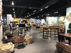 a room filled with lots of furniture and decor on display in front of a wall