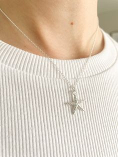 Stunning Sterling Silver Starfish Pendant Necklace. Crafted with meticulous attention to detail, this captivating piece brings the beauty of the ocean to life. Each pendant is expertly handcrafted from high-quality sterling silver, ensuring durability and timeless elegance. The intricate design captures the graceful silhouette of a starfish, symbolising resilience and natural beauty. Whether you're a beach lover, a marine enthusiast, or simply appreciate fine craftsmanship, this necklace is sure Starfish Charm Pendant Jewelry For Gift, Starfish Charm Pendant Jewelry Gift, Star-shaped Charm Necklace With Lobster Clasp As Gift, Gift Star-shaped Charm Necklace With Lobster Clasp, Sterling Silver Starfish Necklace With Star Charm, Ocean-inspired Star Necklaces For Gifts, Starfish Shaped Jewelry With Star Charm As Gift, Starfish Charm Necklace Perfect For Gifts, Starfish Charm Necklace As Gift