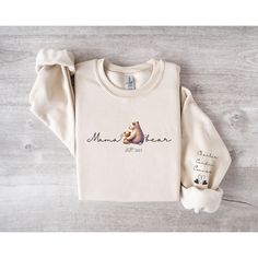 This Custom Mama Bear sweatshirt is perfect for mom's who want to keep their cubs close. Perfect for showcasing your love for your little one's. Custom kid's names are printed on the sleeve, adding a unique and heartfelt touch to this soft, comfortable crewneck. Runs true to size, but size up if you would like a more oversized fit. 50% cotton, 50% polyester Medium-heavy fabric Loose fit Runs true to size All Sweatshirts are Made to Order.  They will ship within one week from one of our printing partners. Please allow sufficient time for production and shipping. If you have any issues or concerns, please absolutely reach out to us directly via Etsy messages so that we can help.  Thank you!  We are truly grateful for your support our Family Business. *Slight variances in color and size are n Mama Bear Sweatshirt, Bear Sweatshirt, Birthday Gift For Mom, Mama Sweatshirt, Mom Sweatshirt, Mama Bear, Mom Birthday Gift, Family Business, Gifts For New Moms