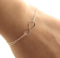 Dainty Infinity Bracelet♥The most simple & delicate everyday bracelet. A very dainty sterling silver infinity charm (20mm) floats amongst two layers of the most dainty & shimmering sterling silver chain. Bracelet is completed with a round spring clasp.★★Need help with your bracelet size? Please measure your wrist, and add 1/2 - 3/4 of an inch for a comfortable fit! Standard size is 7 inches!!★★ ♥Also available in gold fill: https://www.etsy.com/listing/105276481/gold-infinity-bracelet-da Chain Bracelet Tattoo, Gold Infinity Bracelet, Infinity Chain, Bracelets Dainty, Silver Infinity Bracelets, Infinity Bracelets, Bracelet Tattoo, Bridesmaids Gift Sets, Everyday Bracelet