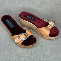 Rescue items are less than perfect with some defects present. Gorgeous Vintage D&G wooden clogs with luxurious velvet lining. Blingy buckles and natural uncoated cowhide tops. The wood is lacquered and shiny. Size 36.5 US or 7 European Missing one crystal, leather has some stains and may need to be reglued in some places SOLD IN AS-IS CONDITION Luxury Brown Clogs With Round Toe, Brown Clogs With Leather Sole And Wedge Heel, Brown Leather Sole Wedge Clogs, Brown Wedge Heel Clogs With Leather Sole, Brown Leather Sole Wedge Heel Clogs, Luxury Brown Closed Toe Clogs, Brown Wedge Heel Clogs With Buckle Closure, Luxury Clogs With Wooden Open Heel, Luxury Leather Clogs With Wooden Heel