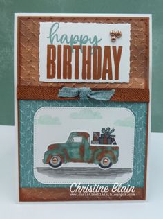 a happy birthday card with an old truck and presents on the back, sitting on a table