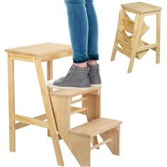 a woman standing on top of a wooden step stool next to a small table and chair